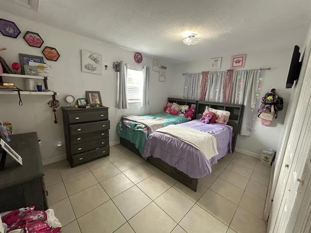 a bedroom with bed and window