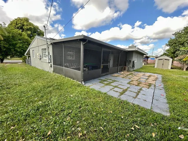 a white house with tree in front of it