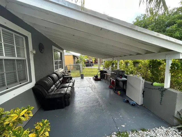 a view of a patio with table and chairs potted plants with wooden floor