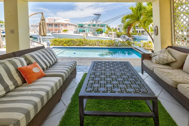 a view of a house with backyard porch and sitting area