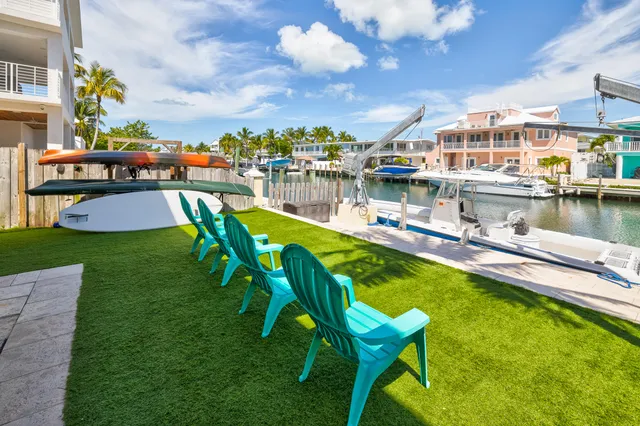 a view of a chairs and table in patio with a swimming pool