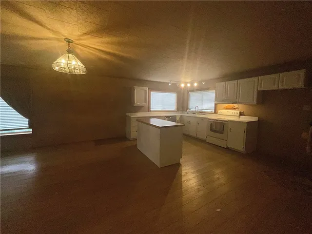 a kitchen with stove and cabinets