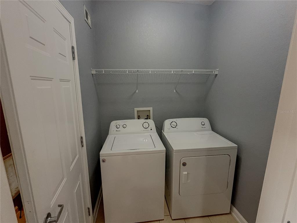 204 Terrace Ridge Circle, Unit 204 Davenport, FL 33896 - Photo 12 of 17 a utility room with dryer and washer