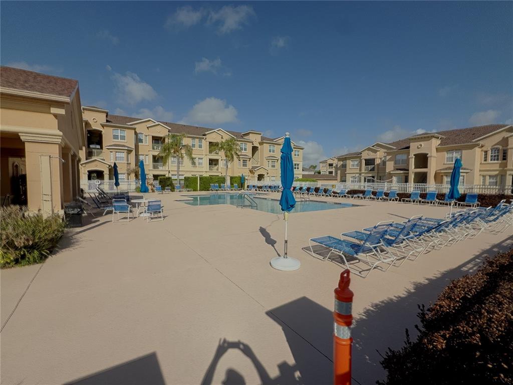 204 Terrace Ridge Circle, Unit 204 Davenport, FL 33896 - Photo 14 of 17 a city view with tall buildings and cars parked on the roadside