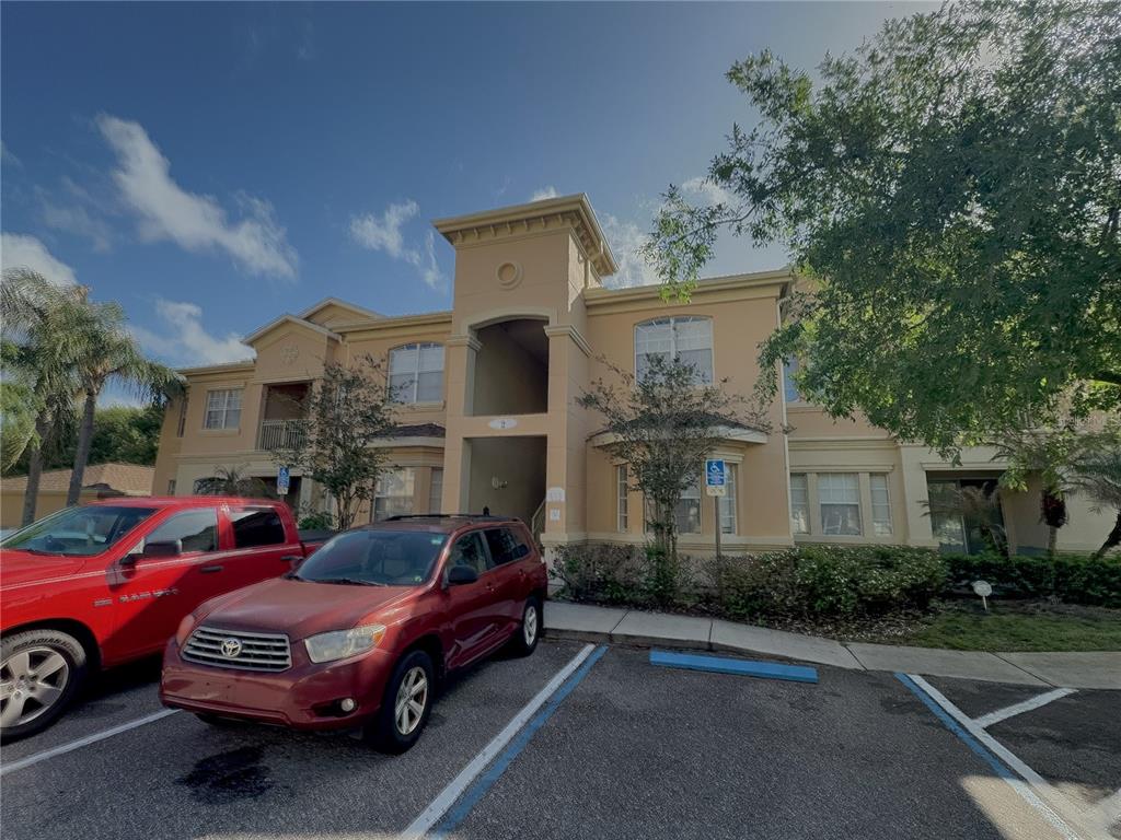 204 Terrace Ridge Circle, Unit 204 Davenport, FL 33896 - Photo 2 of 17 a front view of a house with parking space