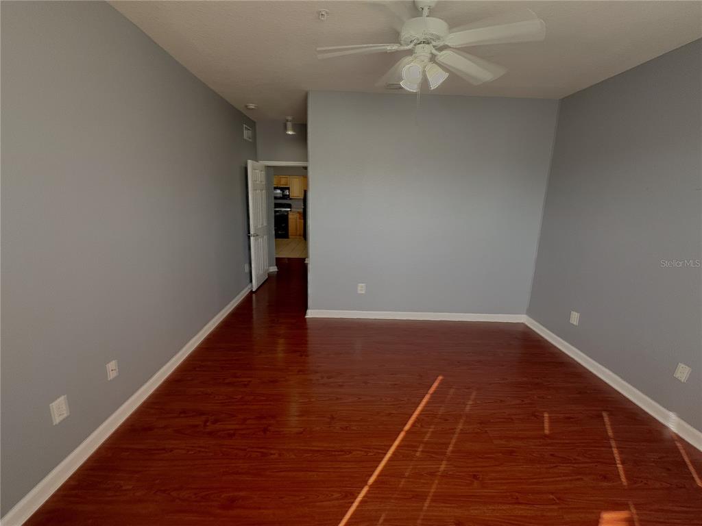 204 Terrace Ridge Circle, Unit 204 Davenport, FL 33896 - Photo 5 of 17 a view of an empty room with wooden floor