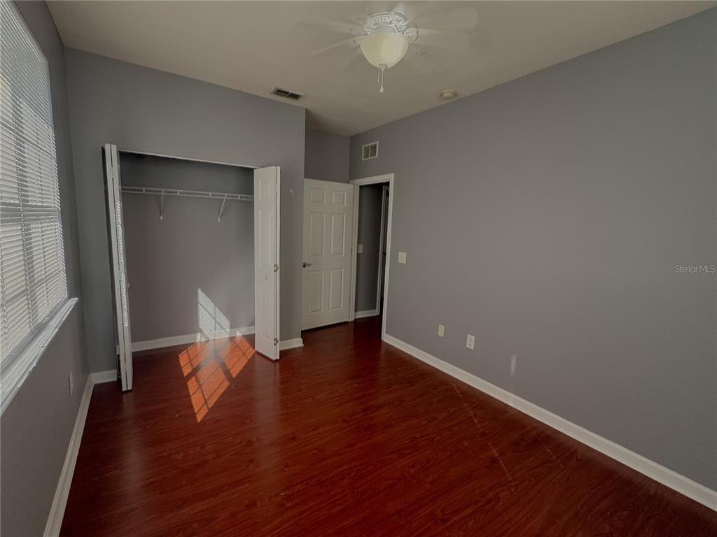 204 Terrace Ridge Circle, Unit 204 Davenport, FL 33896 - Photo 7 of 17 wooden floor in an empty room with a window