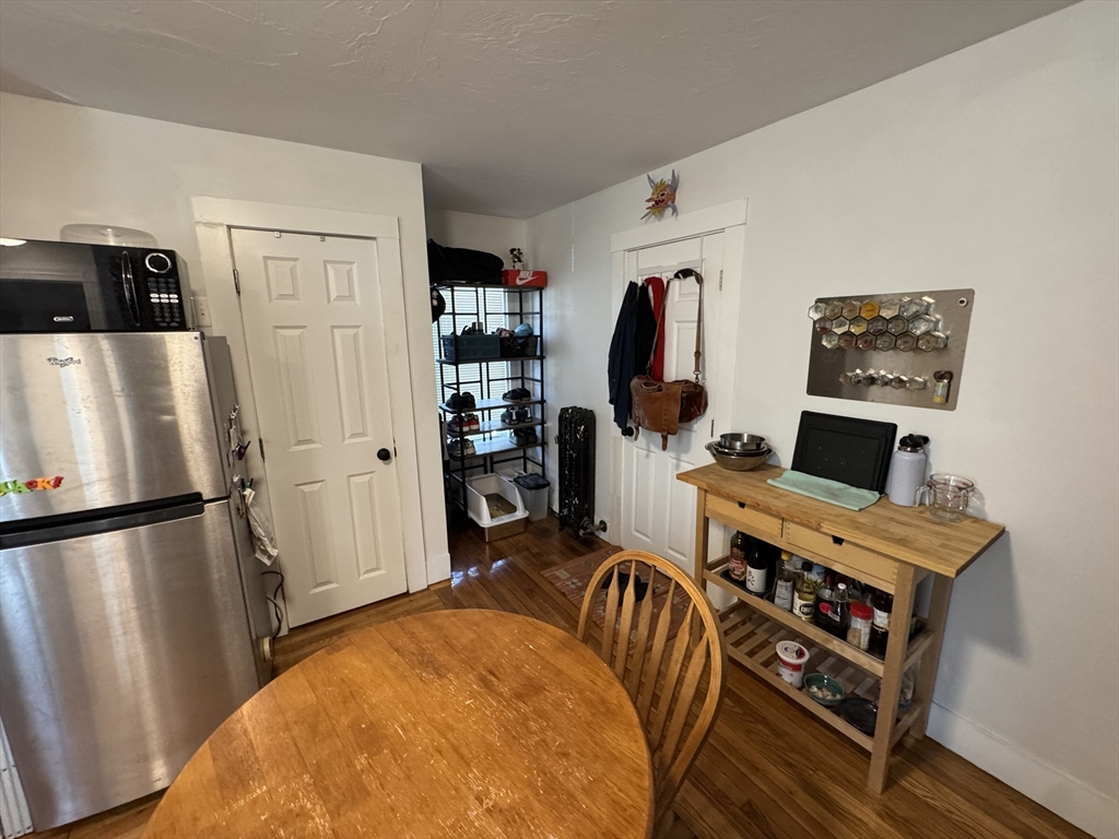 5 Blake Street, Unit 4 Cambridge, MA 02140 - Photo 11 of 14 a view of a kitchen with fridge and workspace