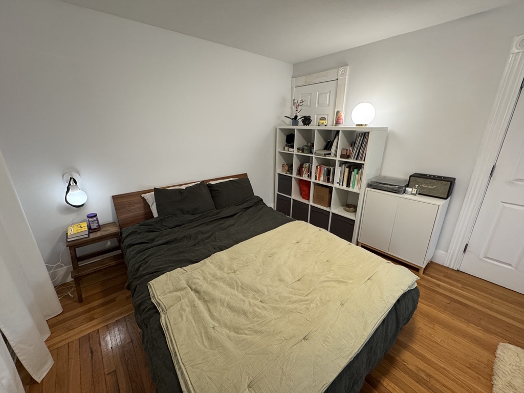 5 Blake Street, Unit 4 Cambridge, MA 02140 - Photo 4 of 14 a bedroom with a bed and wooden floor