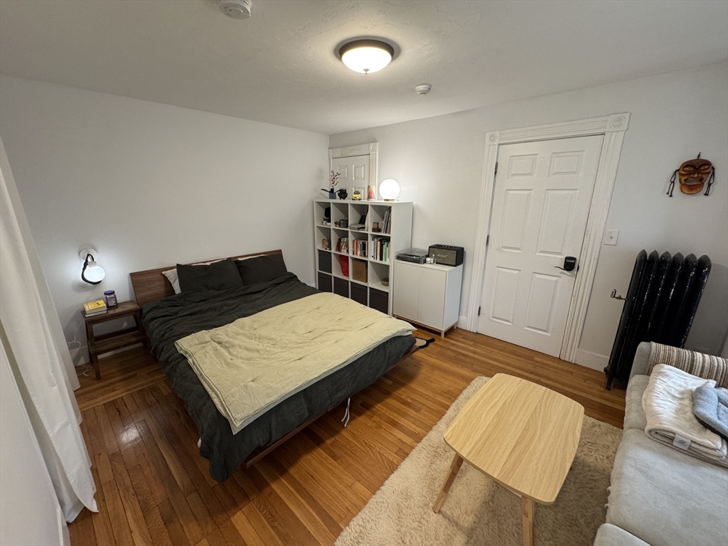 5 Blake Street, Unit 4 Cambridge, MA 02140 - Photo 6 of 14 a bedroom with a bed and wooden floor