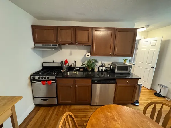 a kitchen with stainless steel appliances granite countertop a stove and cabinets