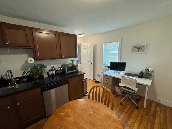 a kitchen with a sink cabinets and black appliances