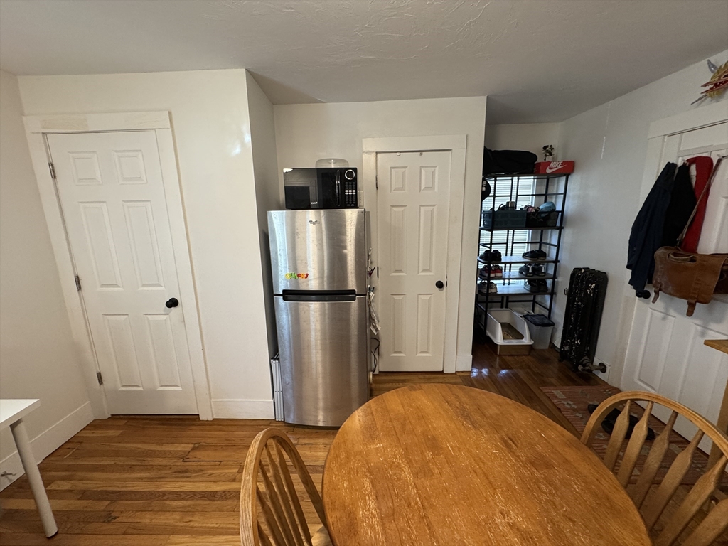 5 Blake Street, Unit 4 Cambridge, MA 02140 - Photo 10 of 14 a bedroom with a bed and a refrigerator
