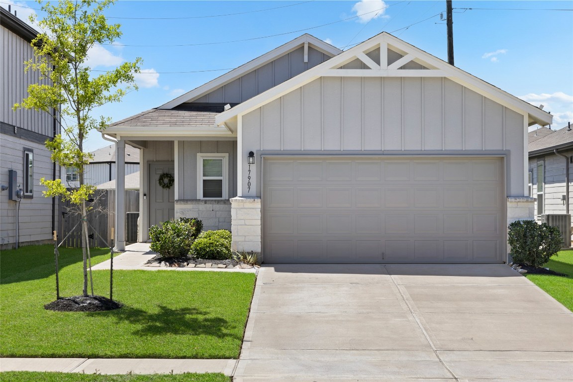 17907 Grain Auger Road Hockley, TX 77447 - Photo 4 of 24 Charming single-story home with a modern facade featuring a two-car garage, neatly landscaped front yard, and inviting entryway. Ideal for comfortable living in a well-maintained neighborhood.