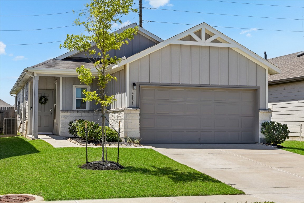 17907 Grain Auger Road Hockley, TX 77447 - Photo 5 of 24 Charming single-story home featuring a modern exterior with a gable roof, two-car garage, and a well-maintained front yard. Perfect for comfortable living in a friendly neighborhood.