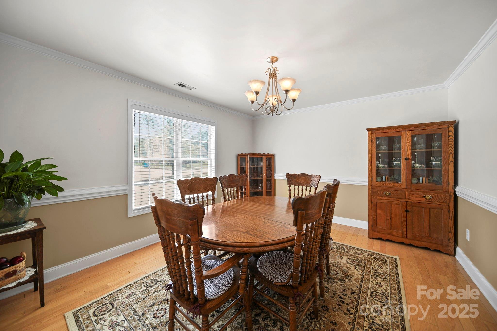 209 Lagoda Drive Locust, NC 28097 - Photo 14 of 43 a view of a dining room with furniture window and wooden floor