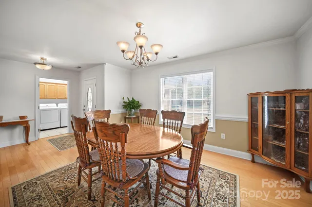 a view of a dining room with furniture and chandelier