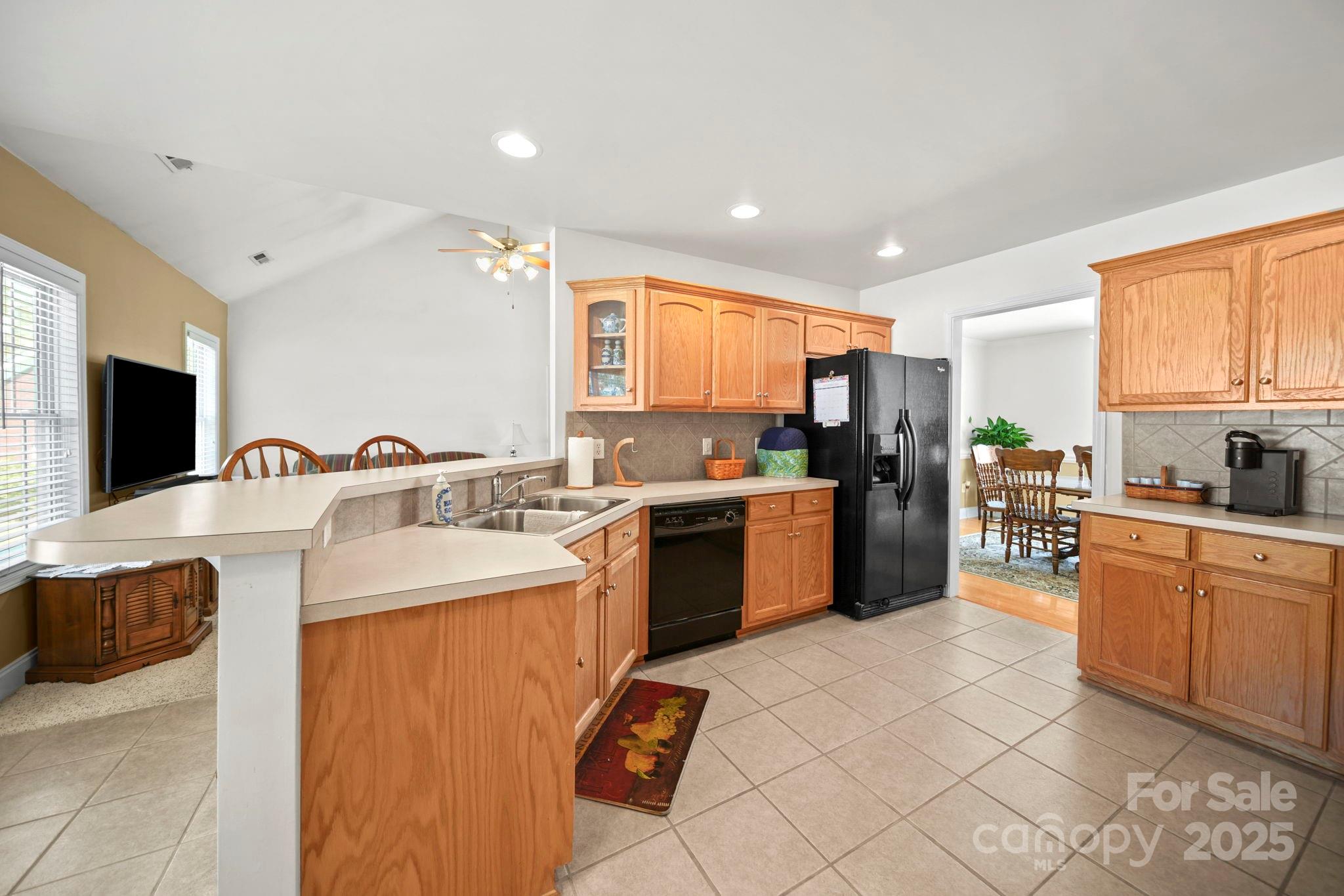 209 Lagoda Drive Locust, NC 28097 - Photo 20 of 43 a kitchen with a sink a counter top space a large window and stainless steel appliances