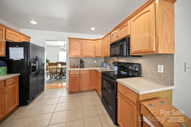 a kitchen with a sink a counter top space stainless steel appliances and cabinets