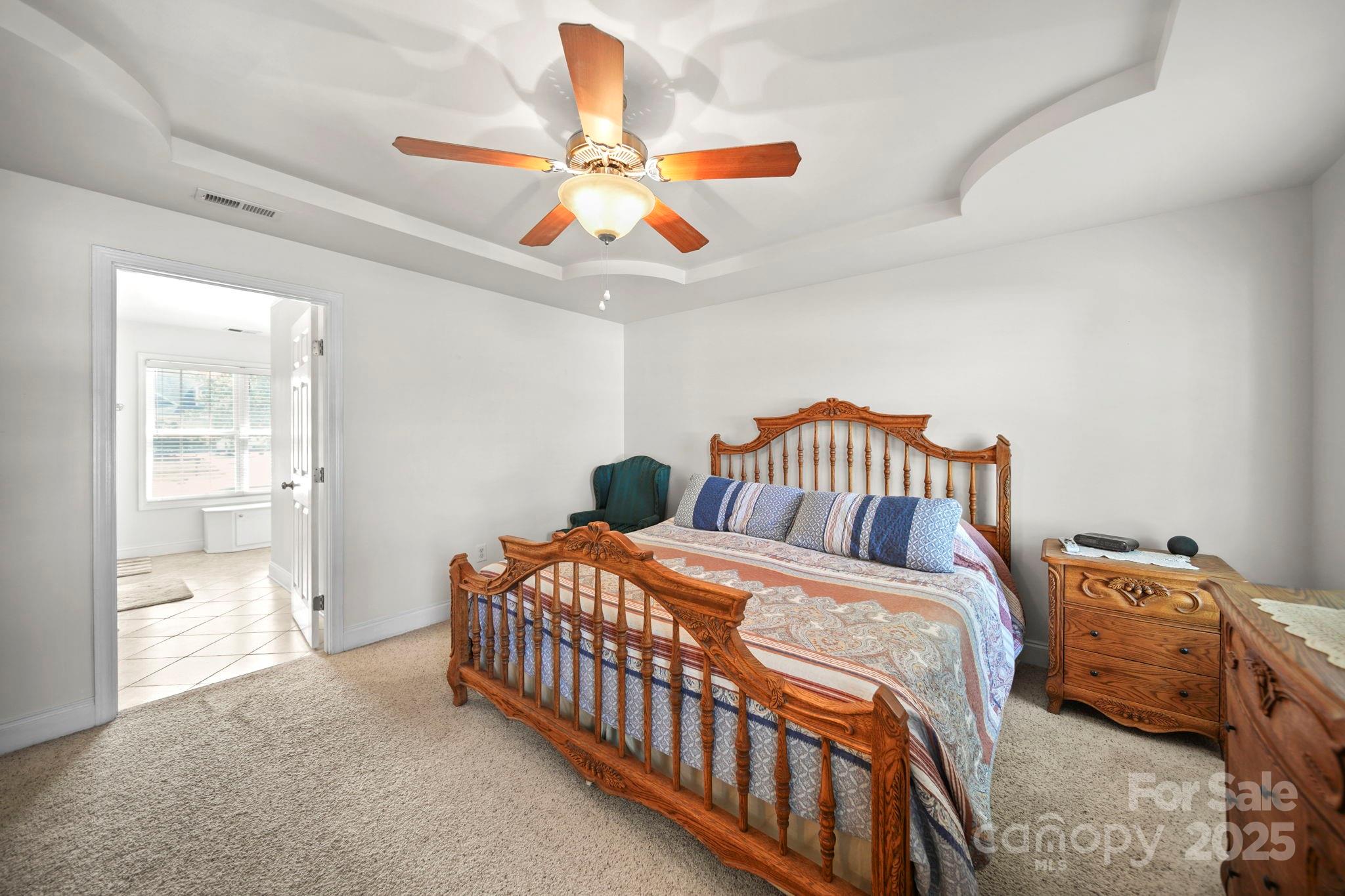 209 Lagoda Drive Locust, NC 28097 - Photo 23 of 43 a bedroom with a bed and a chandelier