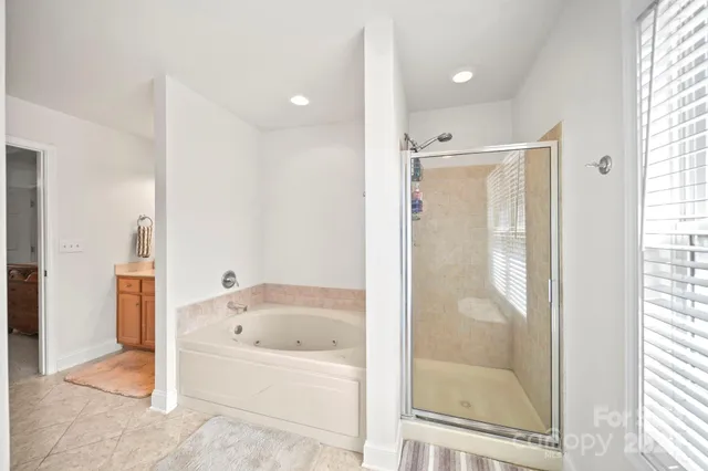 a bathroom with a bathtub and a shower