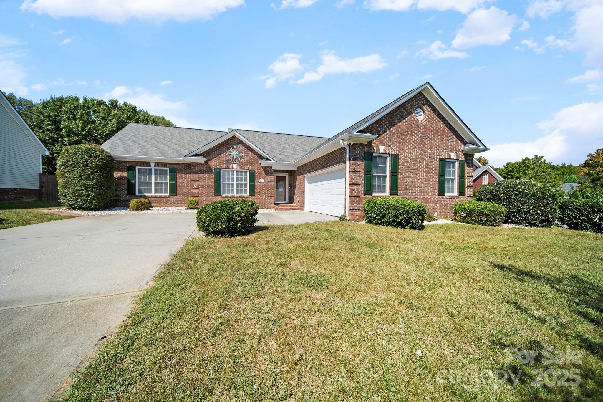 209 Lagoda Drive Locust, NC 28097 - Photo 3 of 43 a front view of a house with a yard and garage