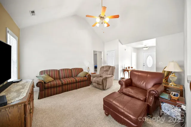 a living room with furniture a couch and a flat screen tv
