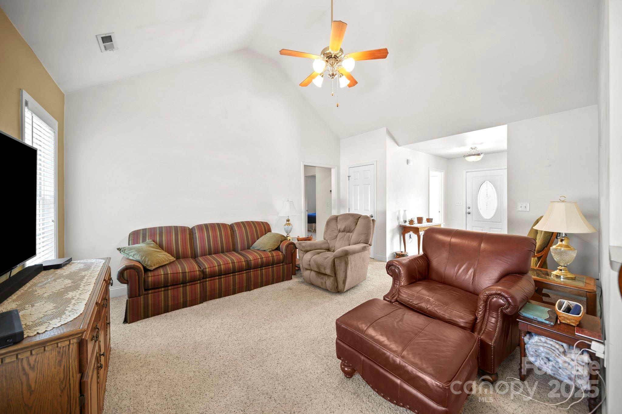 209 Lagoda Drive Locust, NC 28097 - Photo 31 of 43 a living room with furniture a couch and a flat screen tv