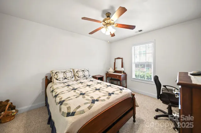 a bed sitting in a bedroom next to a window