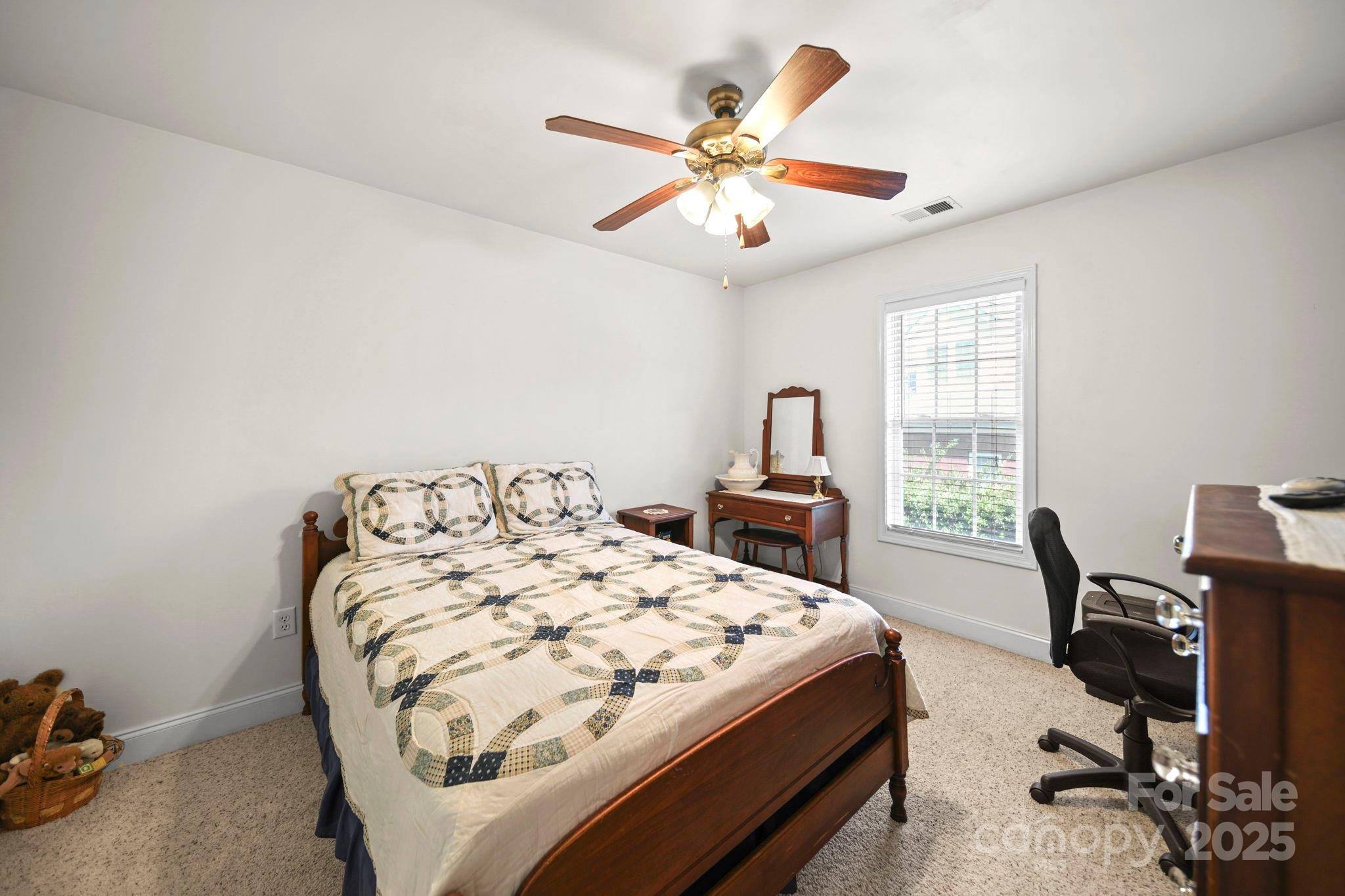 209 Lagoda Drive Locust, NC 28097 - Photo 34 of 43 a bed sitting in a bedroom next to a window