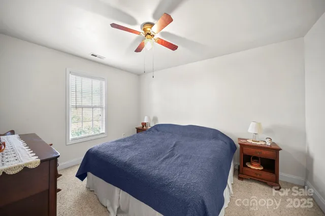 a bedroom with a bed and a tv