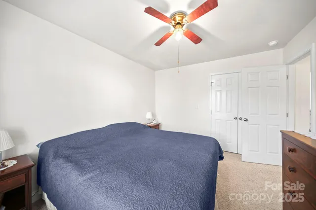 a large bedroom with a bed and a chandelier