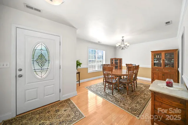 a view of a dining room with furniture and chandelier