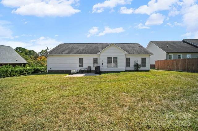 a front view of a house with a garden and yard