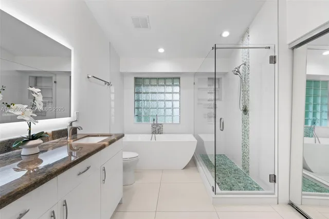 a spacious bathroom with a shower sink and mirror