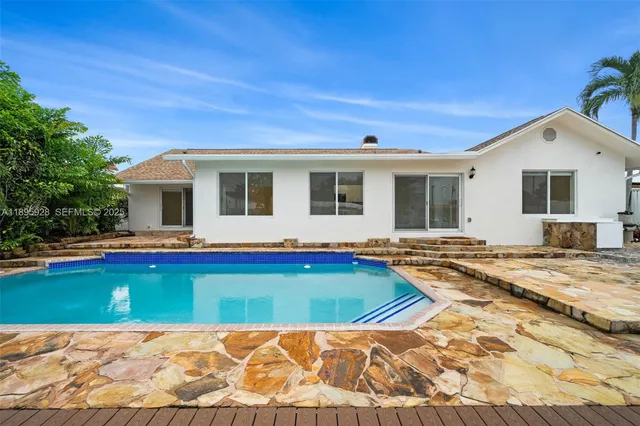 a view of a house with swimming pool and porch