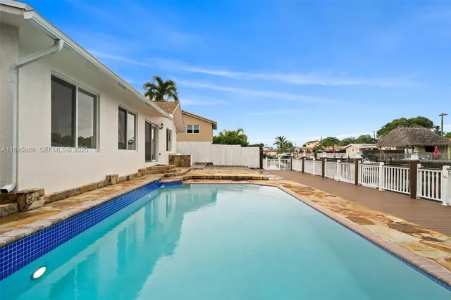 a view of a house with pool and ocean view
