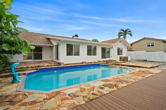 a view of a house with pool and a yard