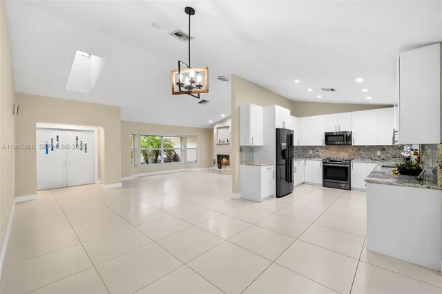 a open kitchen with cabinets and stainless steel appliances