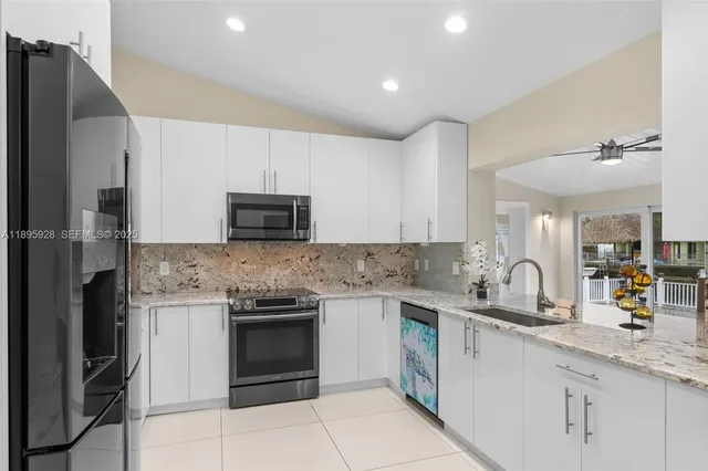 a kitchen with a sink stove and refrigerator