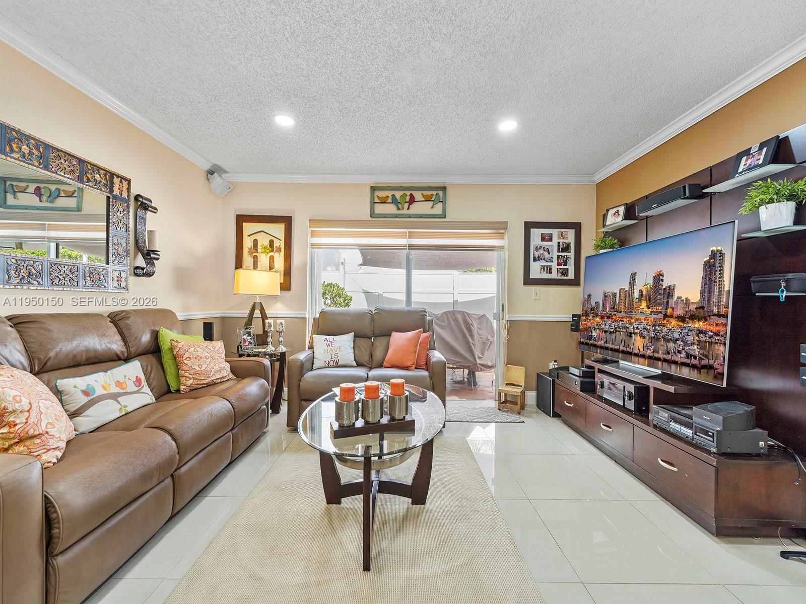 13821 Southwest 102nd Terrace Miami, FL 33186 - Photo 9 of 24 a living room with furniture and a flat screen tv
