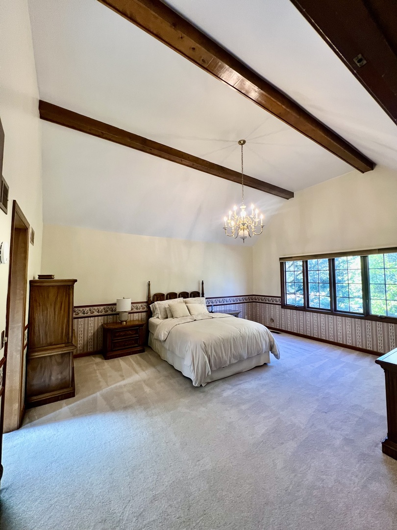 3112 Turnberry Road St. Charles, IL 60174 - Photo 38 of 77 a spacious bedroom with a bed and a couch