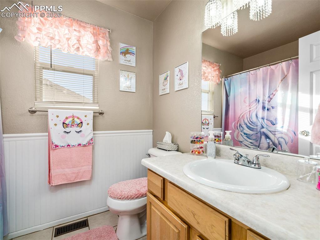 5044 Landmark Road Pueblo, CO 81008 - Photo 17 of 25 a bathroom with a sink vanity mirror and toilet