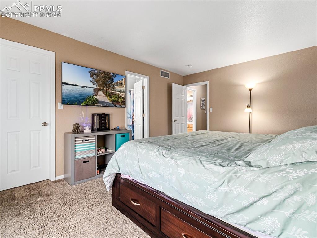 5044 Landmark Road Pueblo, CO 81008 - Photo 19 of 25 a bedroom with a bed and a flat screen tv