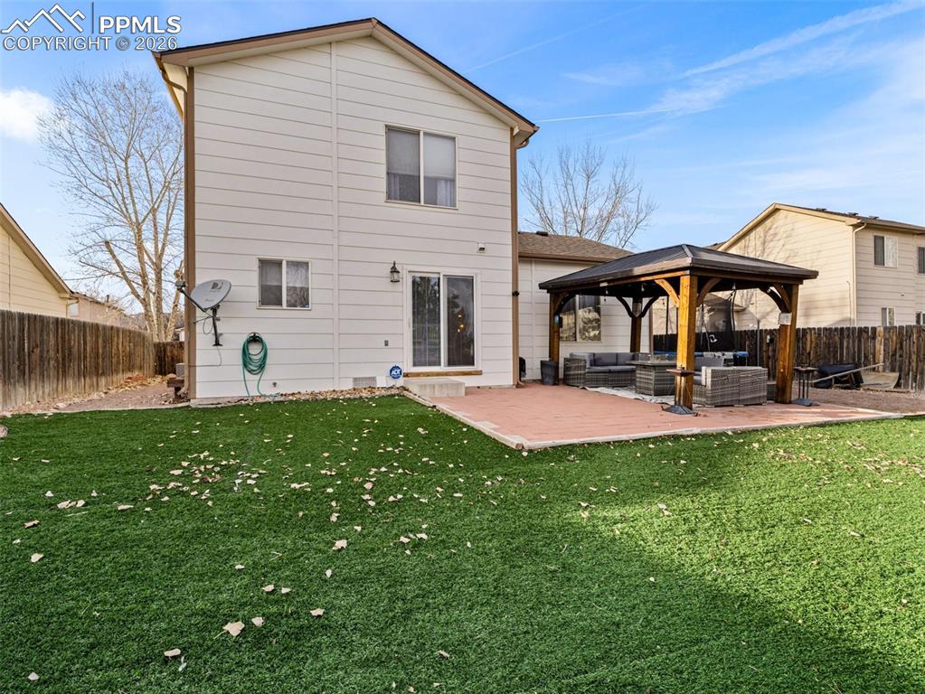 5044 Landmark Road Pueblo, CO 81008 - Photo 22 of 25 a view of a house with backyard and a tree
