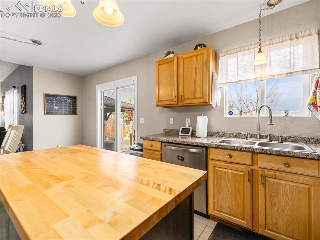 5044 Landmark Road Pueblo, CO 81008 - Photo 9 of 25 a kitchen with stainless steel appliances granite countertop a sink and cabinets with wooden floor