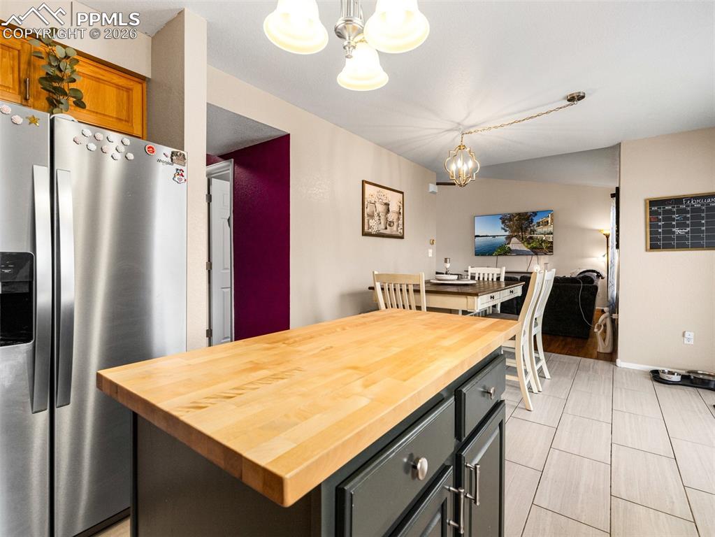 5044 Landmark Road Pueblo, CO 81008 - Photo 10 of 25 a kitchen with stainless steel appliances granite countertop a refrigerator a sink dishwasher a stove and a dining table with wooden floor