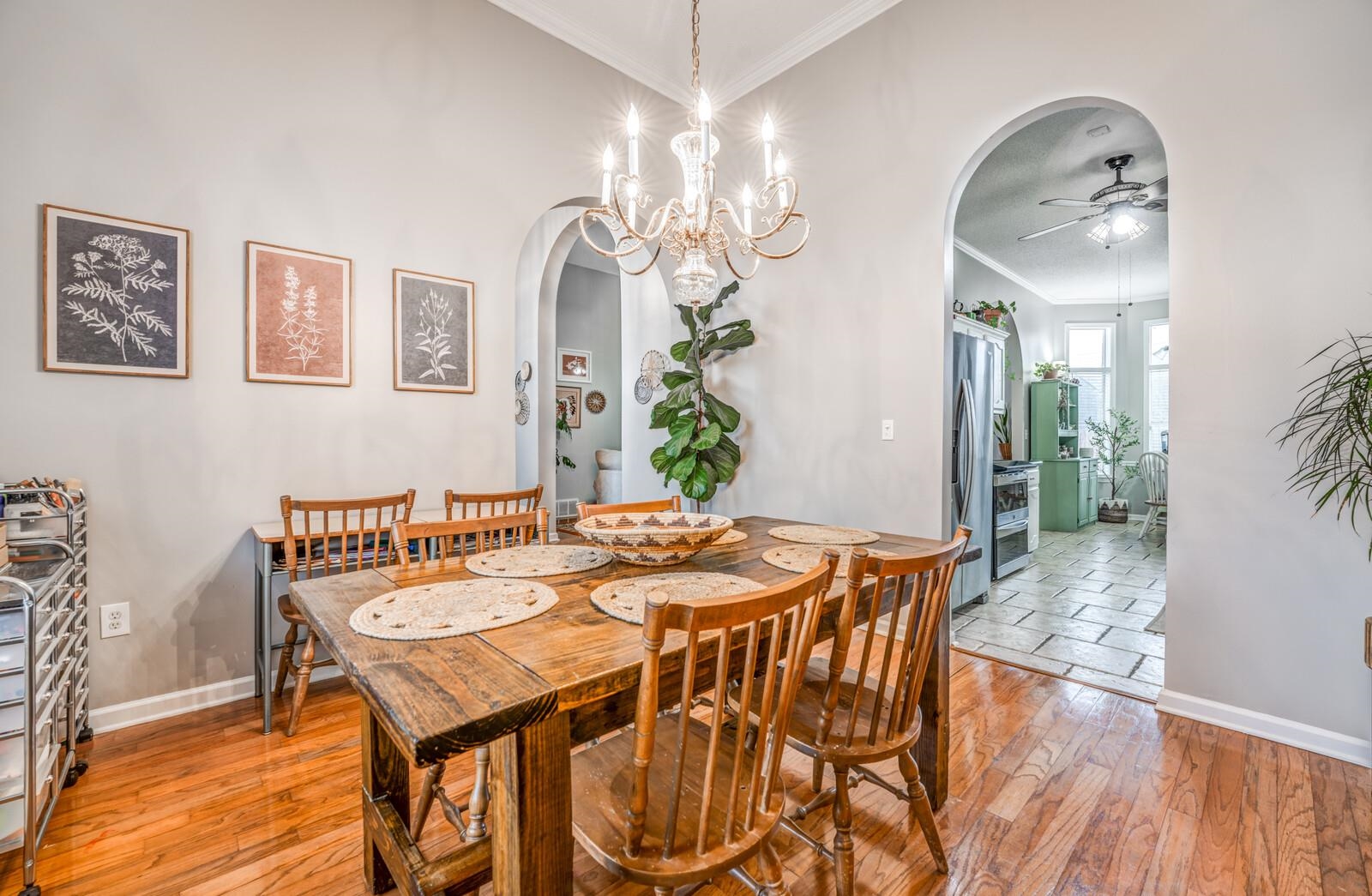6345 Needle Ridge Road Bartlett, TN 38135 - Photo 15 of 39 Dining area with ceiling fan with notable chandelier, ornamental molding, and light hardwood / wood-style flooring