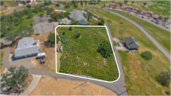 an aerial view of a residential houses with outdoor space