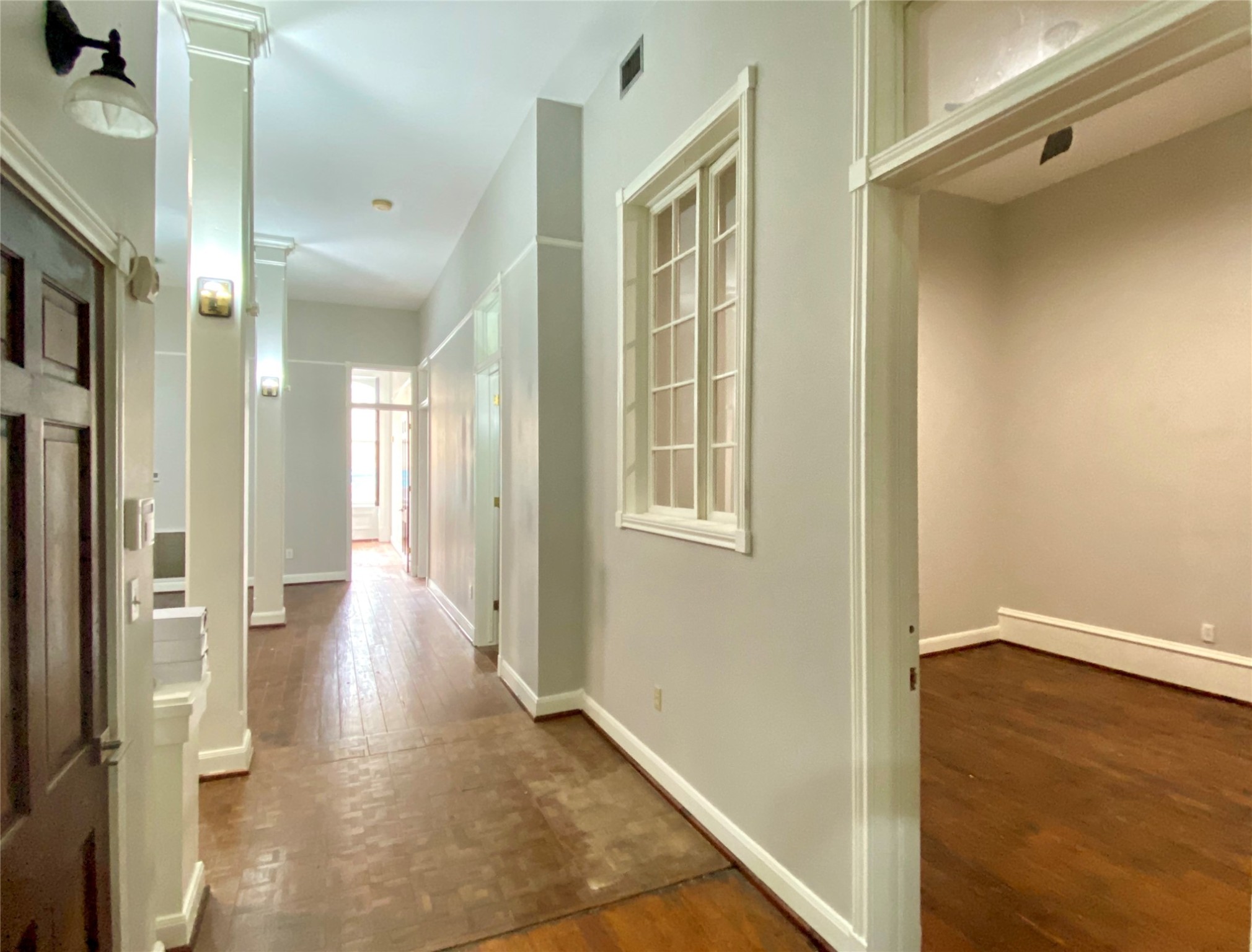2319 The Strand, Unit 2A Galveston, TX 77550 - Photo 20 of 32 a view of a hallway with wooden floor and a bathroom